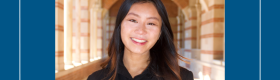 A young woman with long dark hair standing in the UCLA Royce Hall brick arches. She is wearing a black top.