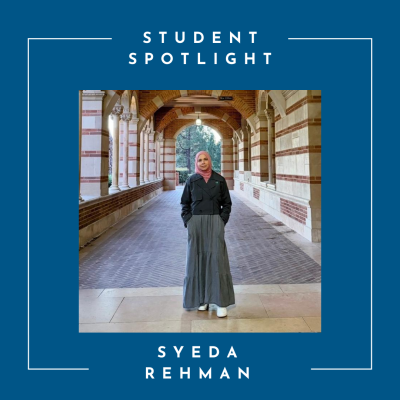 Young woman in hijab and dress stands in the UCLA Royce Hall arches
