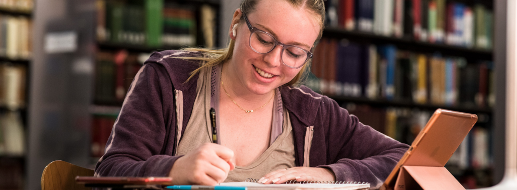 student writing Student writing in a notebook