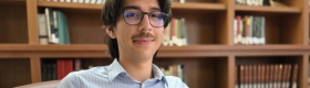 College student reading in a library
