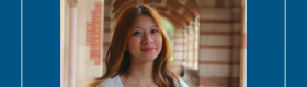 A woman standing in the Royce Hall arches