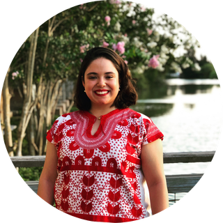 Woman in a floral dress standing outside
